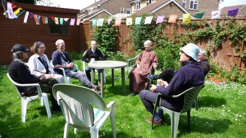 Drinking tea together under the Wesak bunting in the back garden